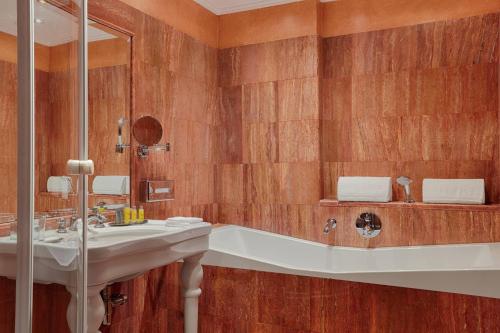 a bathroom with a sink and a bath tub at Rome Marriott Park Hotel in Rome