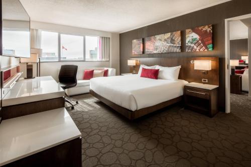 a hotel room with a bed and a desk at Delta Hotels by Marriott Beausejour in Moncton