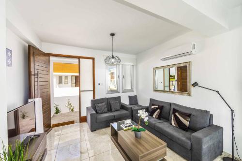 ein Wohnzimmer mit einem Sofa und einem Tisch in der Unterkunft Villa Alasia in Paralimni