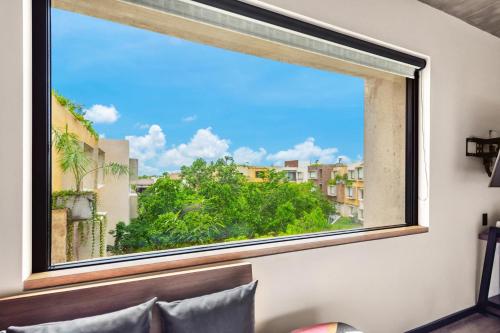 a window with a view of a city at Aloft Tulum in Tulum