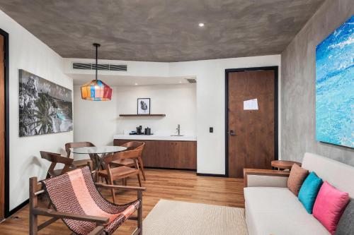 a living room with a table and chairs at Aloft Tulum in Tulum