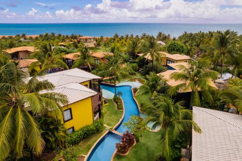 uma vista aérea de um resort com piscina e oceano em Domus Villas em Pipa