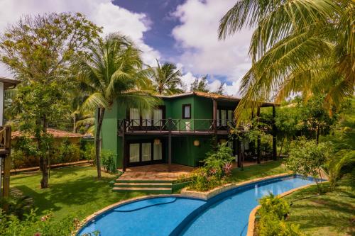 an exterior view of a house with a swimming pool at Domus Villas in Pipa