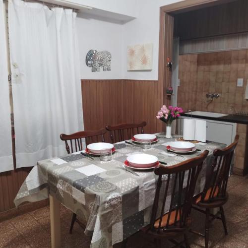 a table with chairs and a table cloth on it at chalet de tata in Tandil