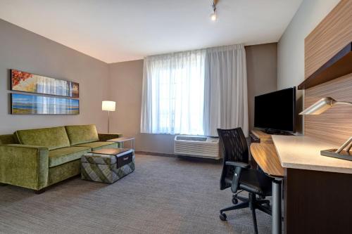 a hotel room with a couch and a desk with a computer at TownePlace Suites by Marriott San Luis Obispo in San Luis Obispo