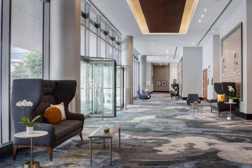 a lobby with couches and chairs in a building at JW Marriott Grand Rapids in Grand Rapids