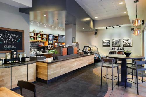 a restaurant with a counter with chairs and a bar at JW Marriott Grand Rapids in Grand Rapids