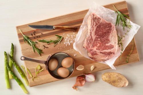 a piece of meat on a cutting board with vegetables at JW Marriott Grand Rapids in Grand Rapids