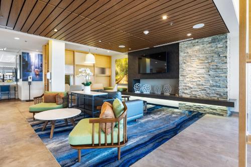a lobby of a hotel with chairs and a table at Fairfield by Marriott Inn & Suites San Francisco Airport Oyster Point Area in South San Francisco