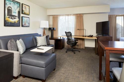 a hotel room with a couch and a desk at Residence Inn San Diego Carlsbad in Carlsbad