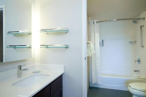 a bathroom with a sink and a toilet and a shower at Residence Inn San Diego Carlsbad in Carlsbad