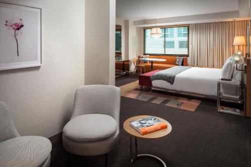 a hotel room with a bed and a table and chairs at SLS Hotel, a Luxury Collection Hotel, Beverly Hills in Los Angeles