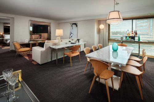 a living room with a couch and a table and chairs at SLS Hotel, a Luxury Collection Hotel, Beverly Hills in Los Angeles