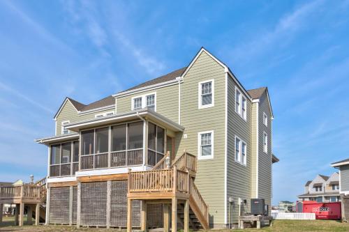 a large house with a porch and a deck at Striper #20A-CAC in Buxton
