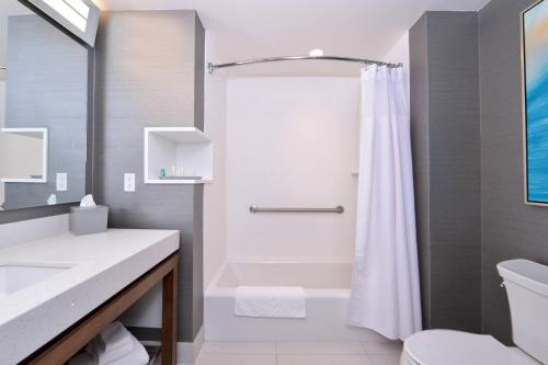 a bathroom with a shower and a toilet at Courtyard by Marriott Saskatoon Airport in Saskatoon