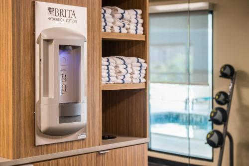 a room with a towel dispenser in a bathroom at TownePlace Suites by Marriott New Hartford in New Hartford