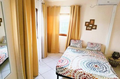 a bedroom with a bed and a window at Appartement Nourou in Pamandzi
