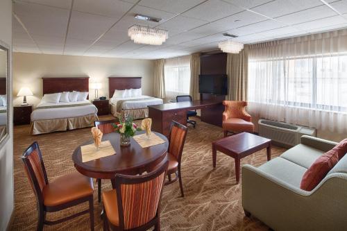 a hotel room with two beds and a living room at Kahler Inn and Suites in Rochester