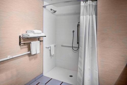 a shower with a shower curtain in a bathroom at Fairfield Inn & Suites by Marriott Los Angeles LAX/El Segundo in El Segundo