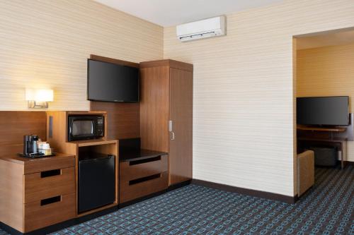 a hotel room with a television and a room at Fairfield Inn & Suites by Marriott Los Angeles LAX/El Segundo in El Segundo