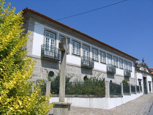 a building with windows and balconies on a street at Quinta do Ouro in Póvoa de Lanhoso