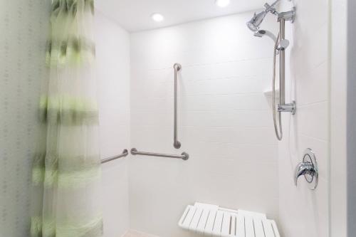 a bathroom with a shower with a bench in it at SpringHill Suites Ewing Township Princeton South in Ewing