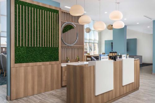 a lobby with a green wall and a reception desk at Element Knoxville West in Knoxville