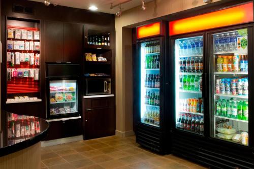 a store with two refrigerators with drinks in them at Courtyard Memphis Collierville in Collierville