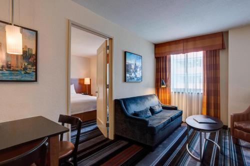 a hotel room with a couch and a bedroom at Residence Inn by Marriott New York Manhattan/Times Square in New York