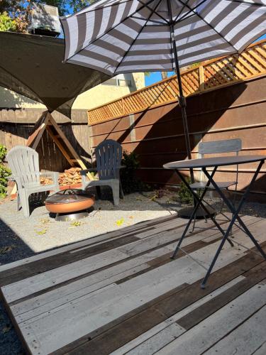 a patio with two chairs and a table and an umbrella at Citrus Studio A in Chico