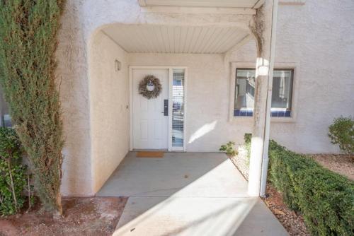 a front door of a house with a wreath on it at Las Palmas Retreat In Sunny St George with Pool in St. George