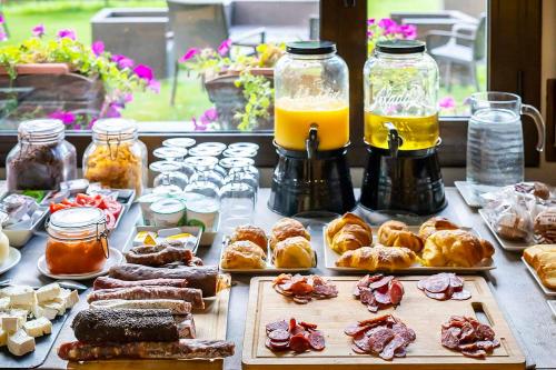 a table with many different types of pastries and drinks at Roca Blanca in Espot