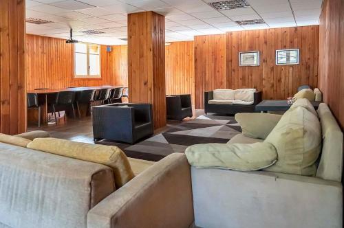 a living room with couches and a table and chairs at Roca Blanca in Espot