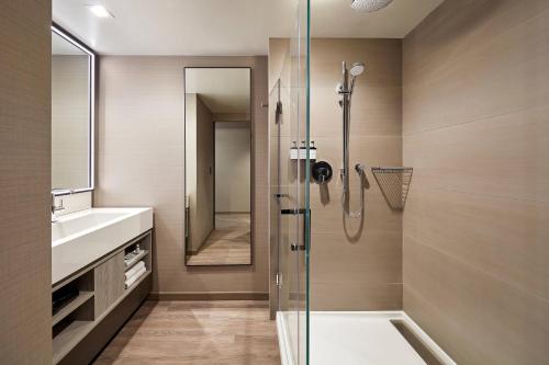a bathroom with a shower and a sink at AC Hotel by Marriott Palo Alto in Palo Alto