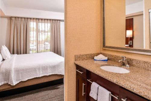 a bathroom with a sink and a bed in a room at Residence Inn by Marriott Florence in Florence