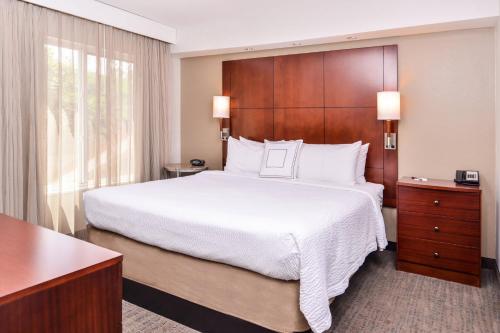 a bedroom with a large bed and a large window at Residence Inn by Marriott Florence in Florence