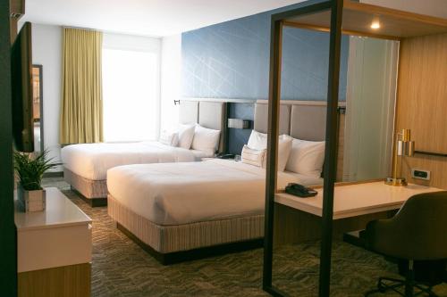 um quarto de hotel com duas camas e uma secretária em SpringHill Suites by Marriott South Bend Notre Dame Area em South Bend