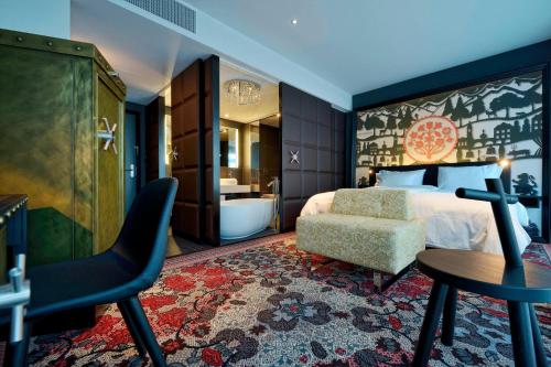 a hotel room with a bed and a bathroom at Kameha Grand Zurich, Autograph Collection in Glattbrugg