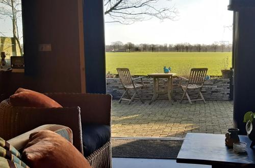 a view of a patio with a table and chairs at 't Prentenhokkie in Stuifzand