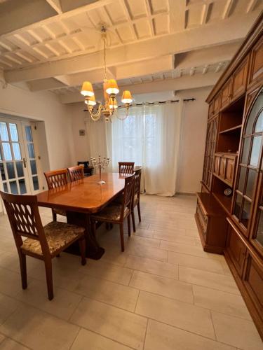 una sala da pranzo con tavolo e sedie in legno di Villino in Campagna con Piscina Relax - La Casa di Teresa a Campomarino