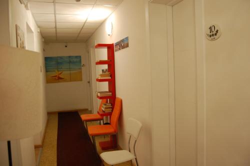 a room with a red ladder with books on the wall at Hotel Irene in Lignano Sabbiadoro