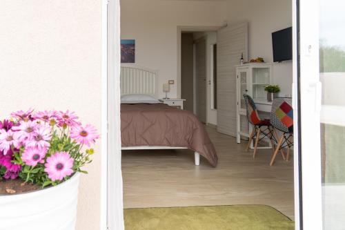 a bedroom with a bed and a table and chairs at Nni Mia in Modica