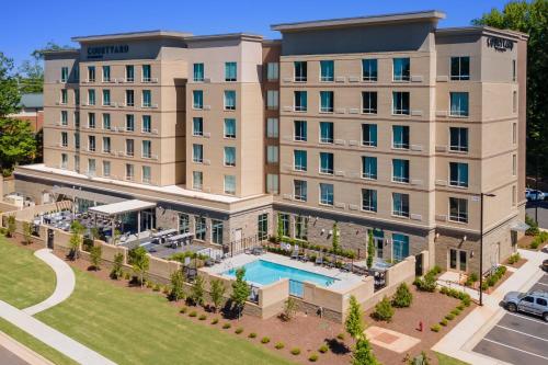 an aerial view of a hotel with a pool at Courtyard by Marriott Raleigh Cary Crossroads in Cary