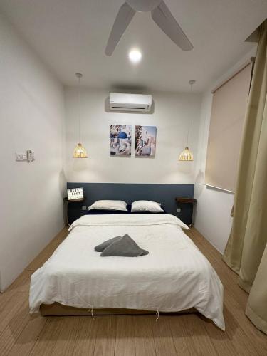 a bedroom with a large white bed with a ceiling at Blest Loft 7 Manhattan Suites ITCC in Penampang