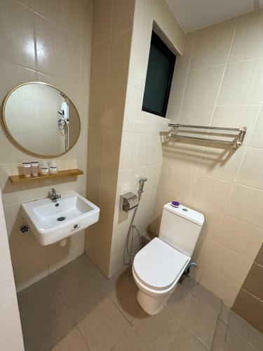 a bathroom with a white toilet and a sink at Blest Loft 7 Manhattan Suites ITCC in Penampang