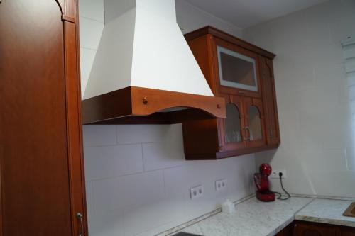 a kitchen with a stove top hood in a kitchen at Casa Rural VILLA KAIROS in Ajofrín