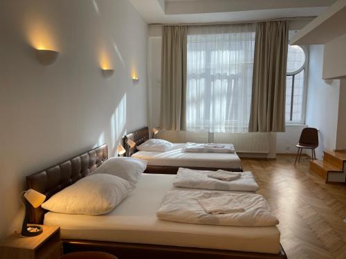 a bedroom with two beds and a window at Corso View in Budapest