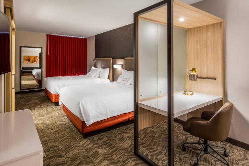 a hotel room with two beds and a desk at SpringHill Suites by Marriott Chambersburg in Chambersburg
