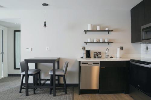 a kitchen with a table and chairs and a sink at Residence Inn by Marriott Providence Lincoln in Lincoln