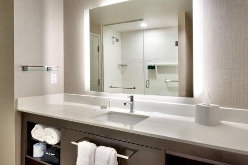 a bathroom with a sink and a large mirror at Residence Inn by Marriott Providence Lincoln in Lincoln